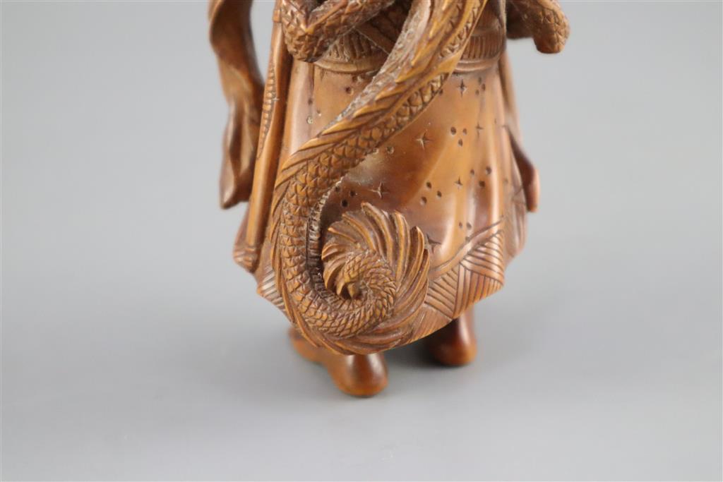 A fine Japanese boxwood okimono of the Sennin Handaka Sonja with a dragon clambering on his back, 19th century, signed Masakazu, 16.5cm